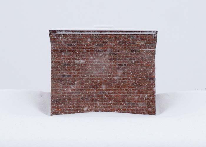 chimney during snowstorm in new england created using thin reclaimed brick tiles.