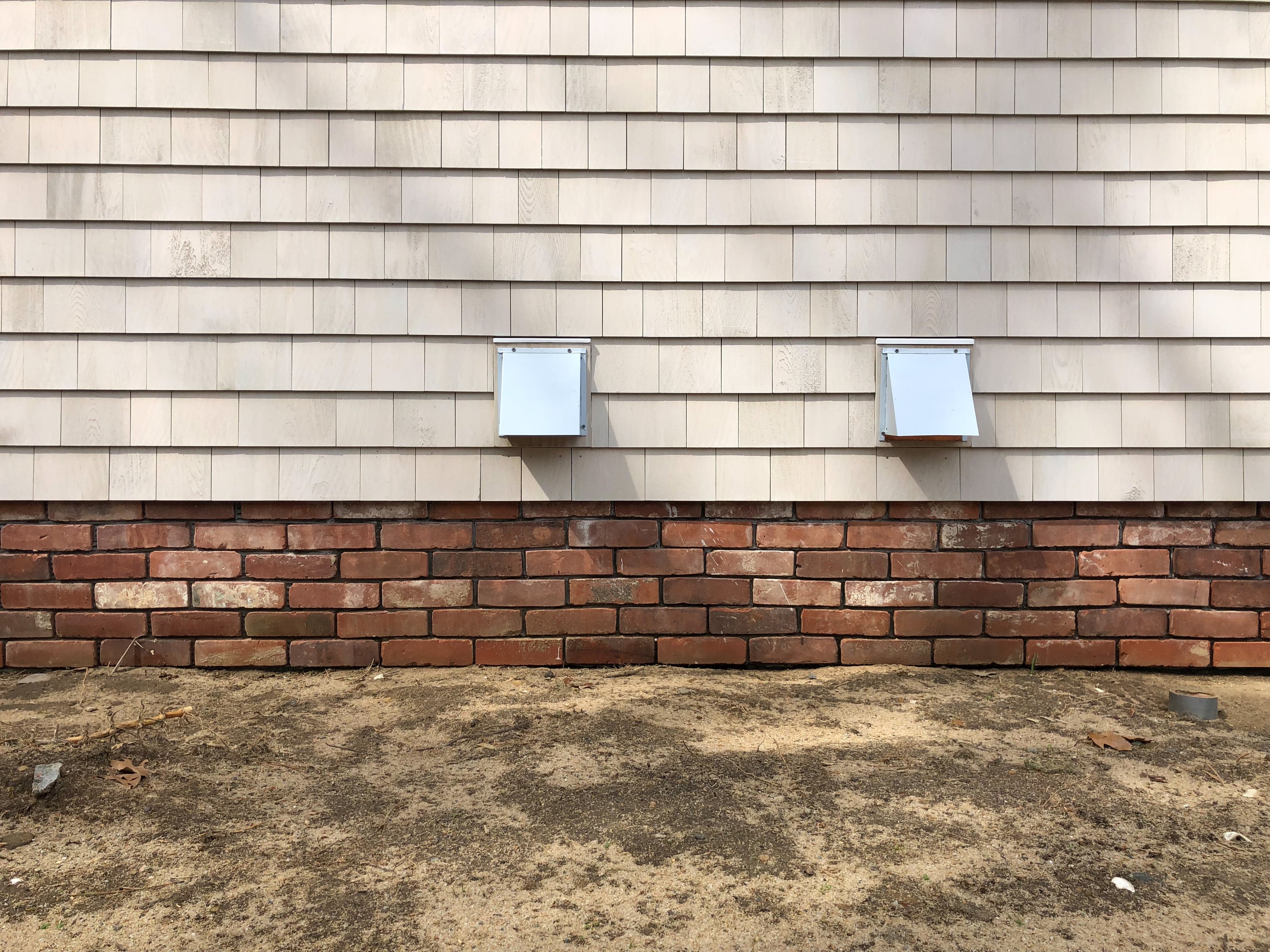 house cement foundation covered in reclaimed thin brick tiles ready for grout between the seams.